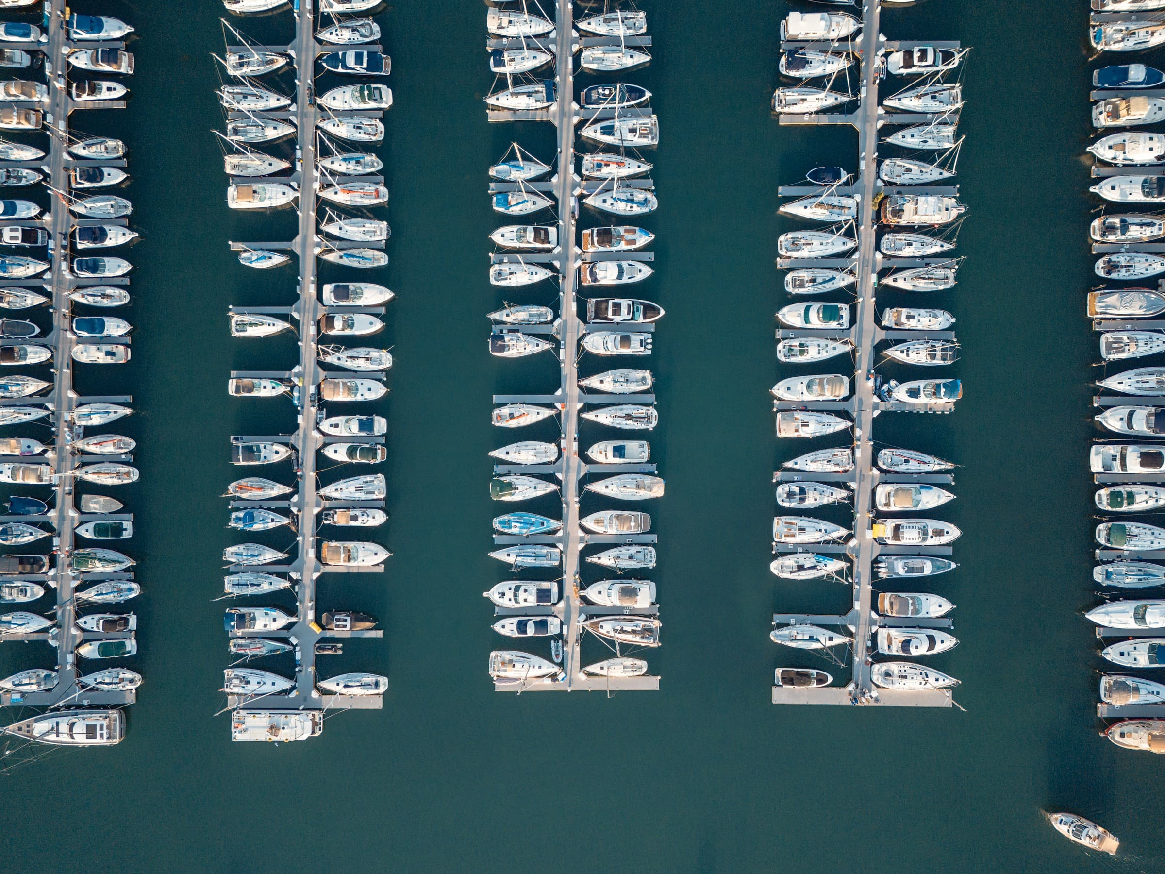Aerial view of marina slips and docked boats